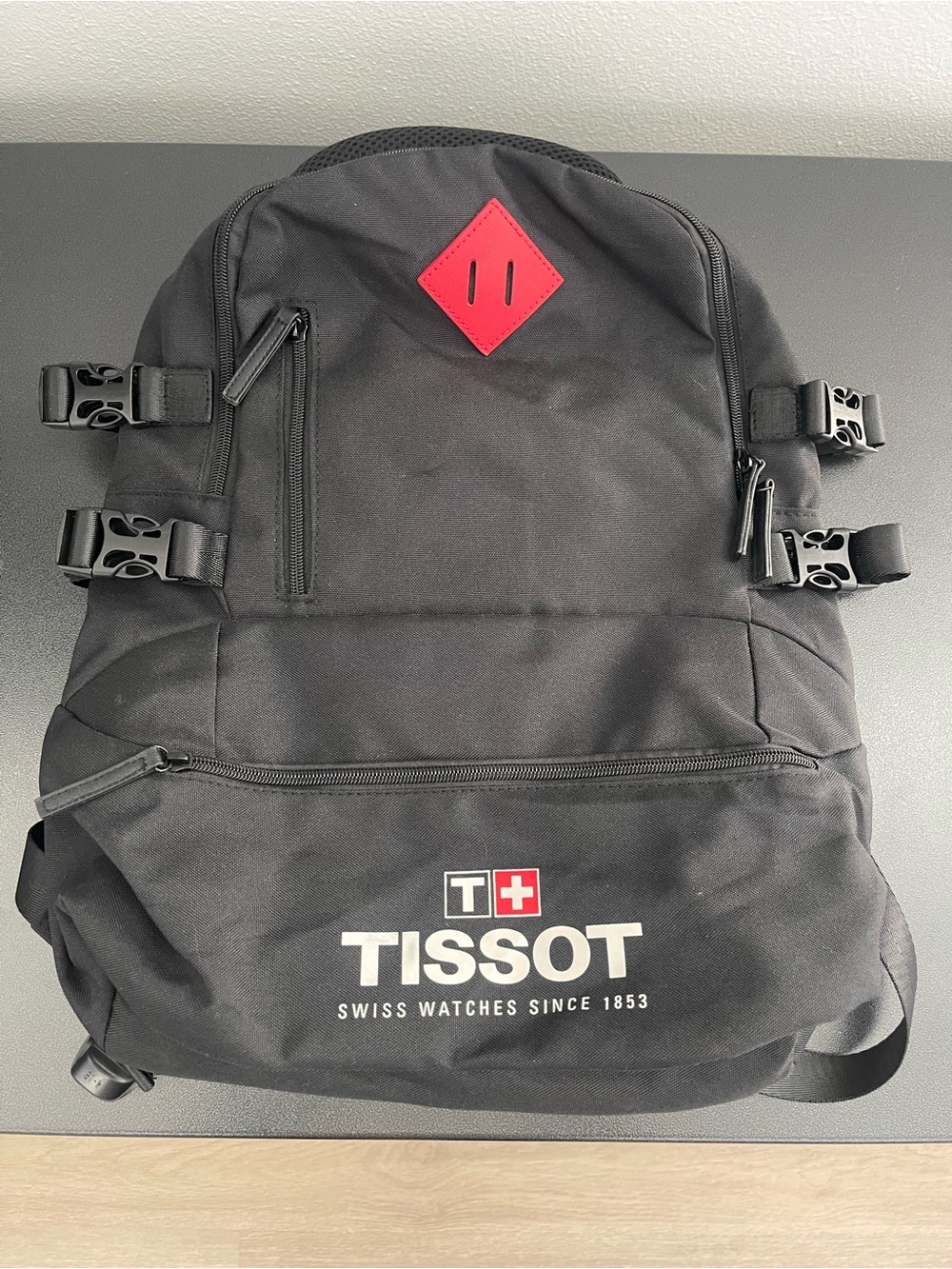 Tissot Black Backpack with Red Diamond Accent